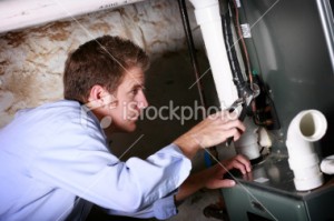 stock-photo-11009432-service-man-working-on-furnace